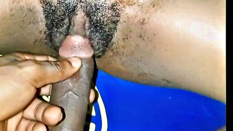 Black hand guiding thick ebony cock into hairy black pussy closeup