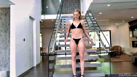 Amber Moore in black bikini and heels, slim blonde posing seductively