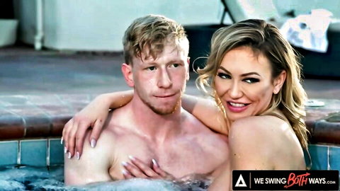 Blonde couple embracing nude in steamy hot tub, bisexual swingers foreplay