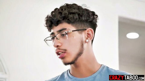 Handsome curly-haired guy in glasses prepping for Kenzie Taylor titjob scene, max 100 chars