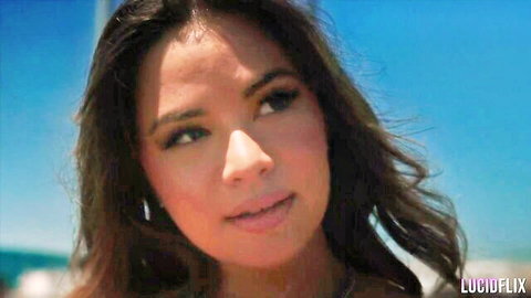 Scarlett Alexis smiling seductively outdoors by the sea, close-up portrait