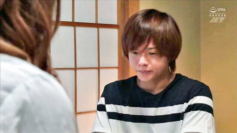 Clothed Asian woman with long hair faces young man in striped shirt in traditional Japanese room.