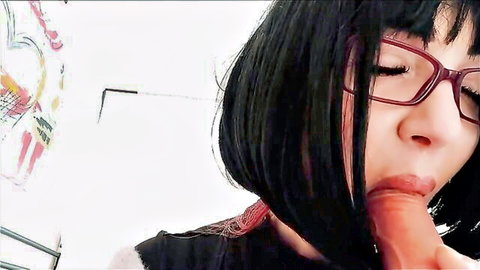 Glasses-wearing babe with black bangs sucks thick cock closeup POV