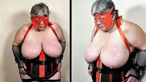 Granny BBW with huge bare tits exposed in red BDSM mask black corset and fishnets