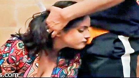 Indian woman in colorful low-cut dress, hair pulled by man in intimate embrace