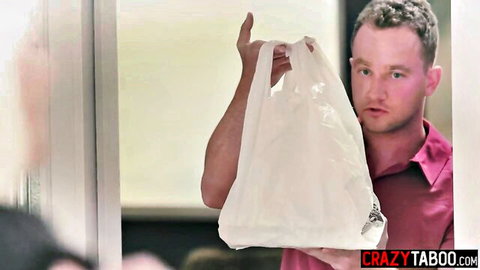Clothed man holding white plastic bag over face at door in pink shirt taboo tease