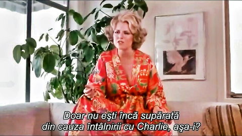 Vintage blonde MILF in red floral kimono robe sitting on couch taboo scene