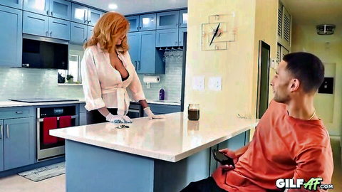 Andi James redhead GILF in open blouse teasing man in kitchen