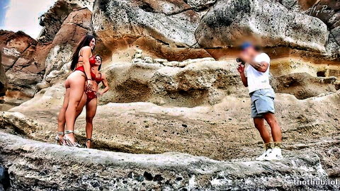 Federica Corona and Alice in red bikinis posing for GentlyPerv on rocky beach