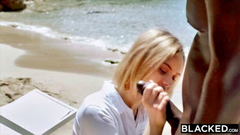 Peta Jensen kneels on beach giving blowjob to black bull in Blacked interracial scene