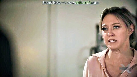 Emotional blonde MILF stepmom in pink blouse, intense gaze