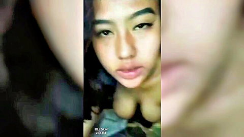 Indonesian woman with deep cleavage in low-cut top, amateur selfie