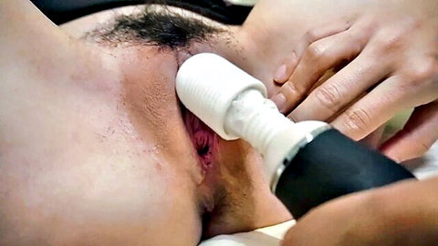 Close-up of shaved Asian pussy penetrated deep by thick white Magic Wand vibrator head