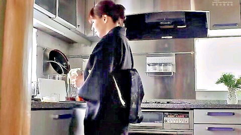 Japanese woman in black kimono cooking in modern kitchen stove
