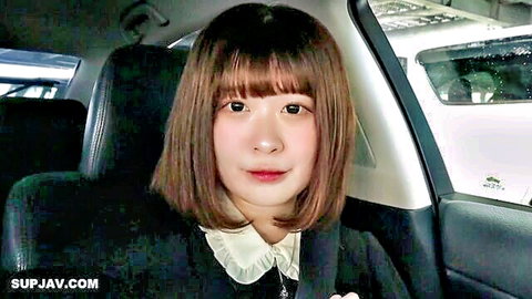 Cute Asian teen babe in schoolgirl uniform smiling in car