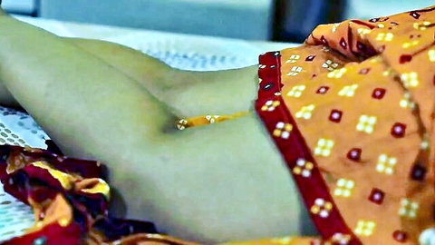 Desi Indian woman in orange sari spreading legs exposing pussy