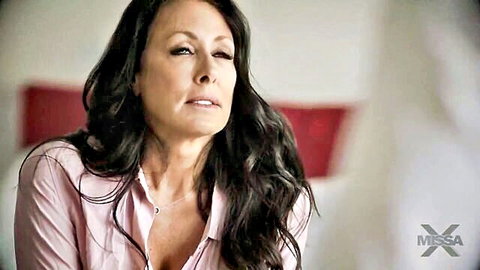 Tina in seductive pink blouse with cleavage, mature bedroom gaze