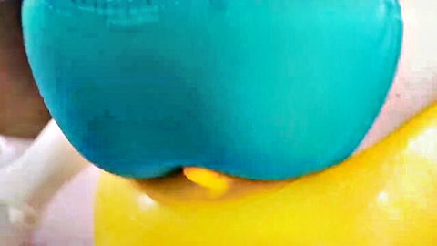 Big Asian ass in teal bikini with yellow dildo insertion, bending over