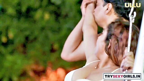 Indian couple embracing intimately on outdoor swing, woman in sheer white dress, Ullu series tease