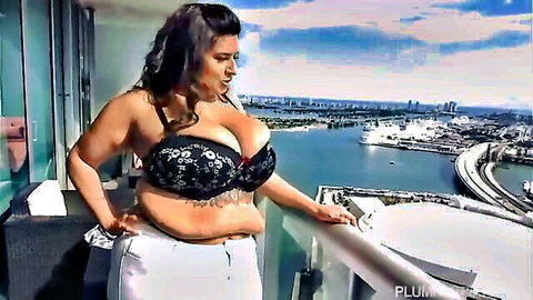 Curvy Latina Sofia Rose in lace bra on Miami balcony view