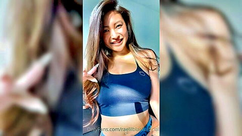 Lilblackrae smiling in black sports bra, teasing cleavage for JOI