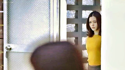 Nene Yoshitaka in yellow sweater and skirt, seductive doorway pose