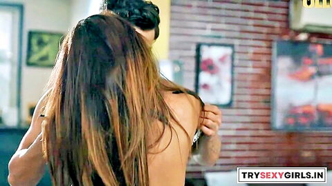 Indian woman topless, long brown hair, embraced by man from behind in web series