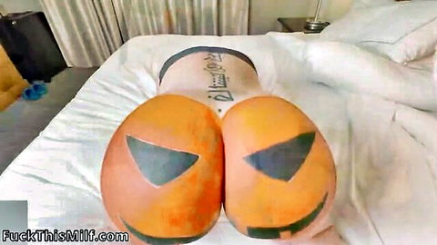 Halloween babe's huge orange jack-o-lantern painted ass cheeks spread wide exposing pink pussy