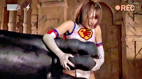 Busty Asian in superhero cosplay teases with large black dildos