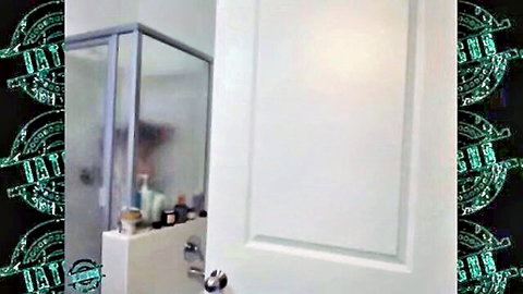 Mia Khalifa showering behind frosted glass in steamy bathroom
