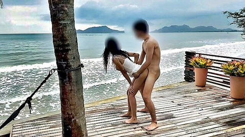 Thai couple outdoor beach doggy style sex on wooden deck