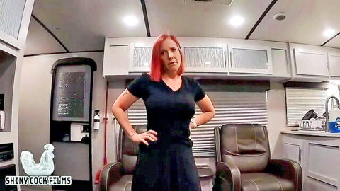 Mature redhead Jane Cane in black dress as step-aunt, seductive pose