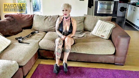 Tattooed Pixie Peach in black lingerie and heels, seductive pose