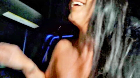 Smiling brunette MILF topless in car, teasing adult scene