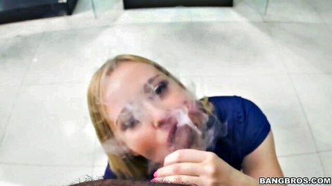 Blonde Kate England exhaling smoke from monster pipe in close POV