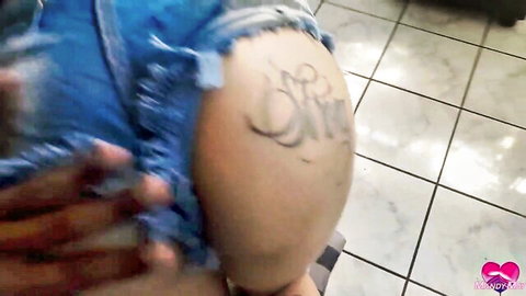 Curvy Latina teasing tattooed big ass in ripped denim shorts