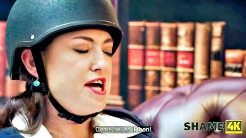 Brunette MILF in riding helmet seductively mouths 'Come on dad bend' in library