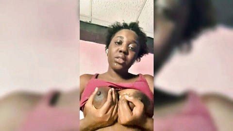 Solo black woman grabbing her full tits in pink top selfie