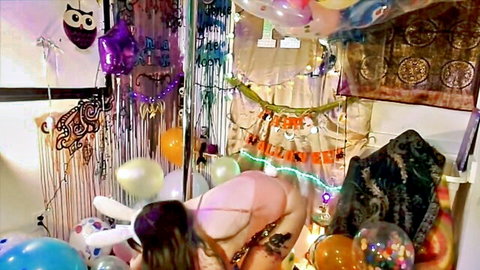 Nude babe in pink bunny ears crawls on all fours showing big juicy ass in Halloween balloon room