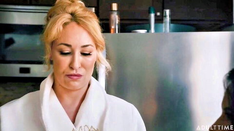 Blonde MILF in white bathrobe pouting seductively in kitchen before fucking