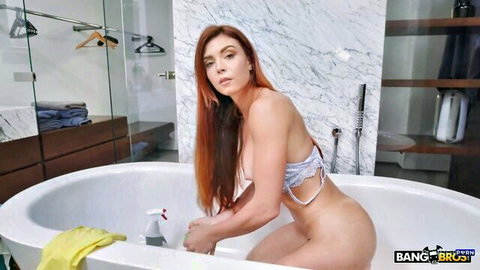 Peach Lollypop topless redhead cleaning bathtub in sexy bikini bottoms