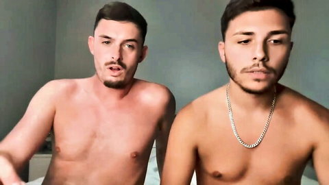 Two shirtless young men lounging on bed, gay amateur thumbnail
