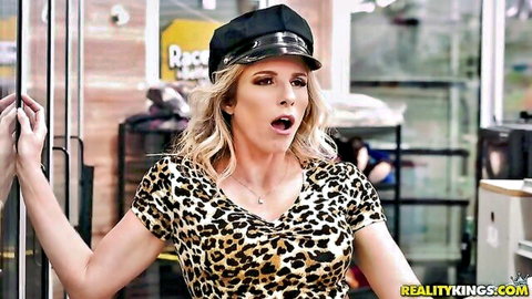 Blonde MILF in leopard top and cap, surprised expression in public car scene