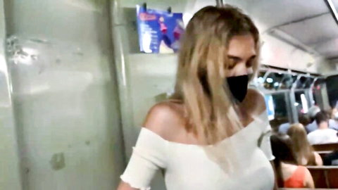 Blonde beauty in off-shoulder top on subway, remote vibrator play by boyfriend