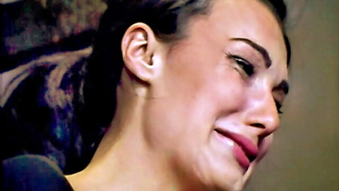 Teary-eyed brunette woman cries in humiliation punishment with tears streaming down her face