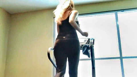 Blonde MILF in tight leggings running on treadmill, curvy ass view