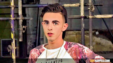 Surprised young twink with short hair in floral jacket outdoors at boynapped