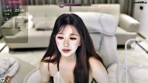 Stunning Asian beauty with long black hair in white lingerie, solo pose on cam