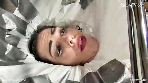 Queensnake in squirt bath, intense wet fetish scene with foil wrap