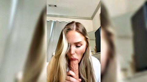 Young blonde babe sucking thick realistic dildo deep in mouth closeup